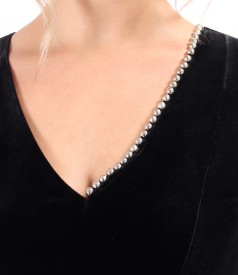 Elegant dress made of black elastic velvet with pearls at the neckline