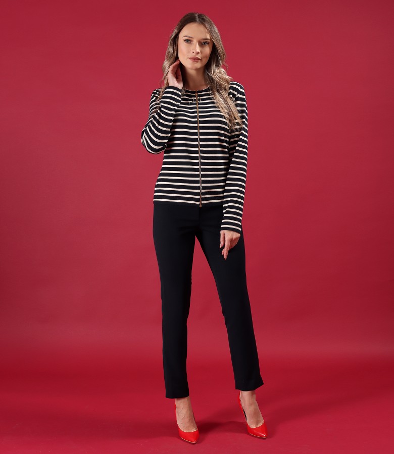 Elegant outfit with ankle pants and striped blouse with zipper on the middle of the front